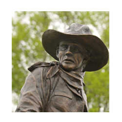 A close up of a larger than life bronze statue of a Ranger on a horse.