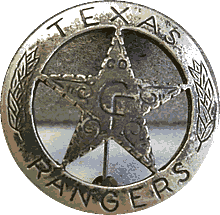 A silver circle star badge with the word "Texas" at the top of the circle and "Ranger" at the bottom. In the center of the star is the words "Co. F". There are leaves up the side of the circle and swirls in the middle of the star.