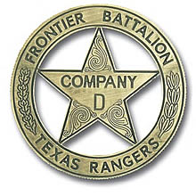 A gold circle star badge with the words "Frontier Battalion" along the top of the circle, "Texas Rangers" along the bottom, and "Company D" in the center of the star. There are swirls decorating the spaces in the star without words and leaves going up the side of the circle..