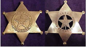 Two gold sheriff's star shaped badges. One with the circle star shape in the middle with the Texas Flag in the middle of the star, branches on the sides of the circle, and the words "Texas Ranger" on the top and bottom. The other with the circle star shape in the middle with the word "Texas" in the middle of the star, branches on the sides of the circle, and the words "Texas Ranger" on the top and bottom.