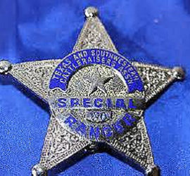 A silver star badge with a blue circle in the center with the words "Texas and Southwestern Cattleraisers Assn" across the top of the circle. Across the