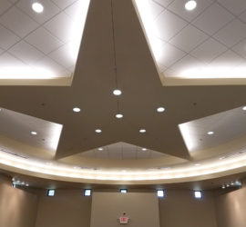 The ceiling of a round building with a large star in the center.