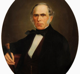 A circular portrait of an older man in a dark suit holding a cane.