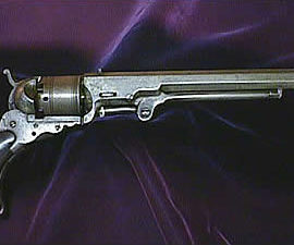 A pistol on a purple background