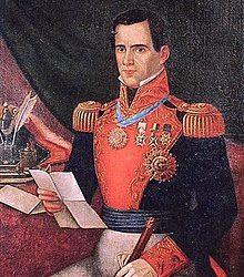 A painted portrait of a man in an elaborate military uniform seated looking at a letter with a sword in his lap.