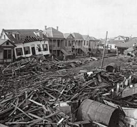 A neighborhood street full of debris and ruined houses.