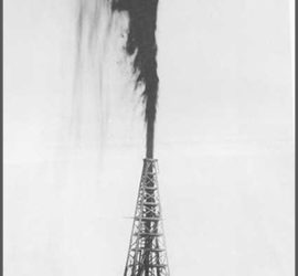 An oil pump spewing oil far into the air with a crew visible at the very bottom.