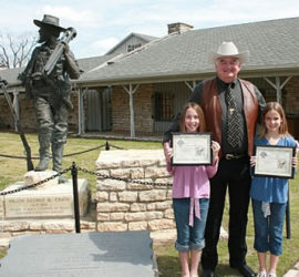 Texas Ranger with two kids by Erath statue