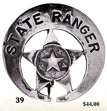 A silver circle star badge with the star closer to the bottom rather than centered. The words "Sate Ranger" are printed at the top and in the middle of the star is another star with the letters of the word "Texas" arranged with one letter between two star points.