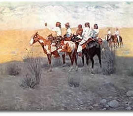 A group of Apache Native Americans on horses in a desert landscape.