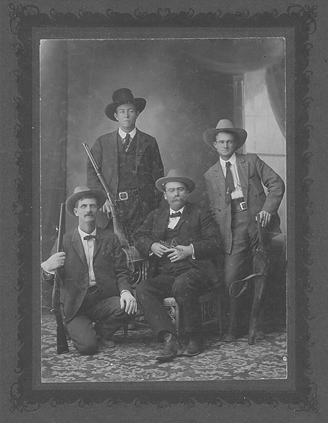 Captain John H. Rogers holding German Luger pistol, along with other Rangers including Frank Hamer, 1906. From the Hamer collection.