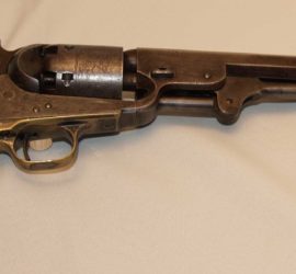 A metal pistol with wooden grips.
