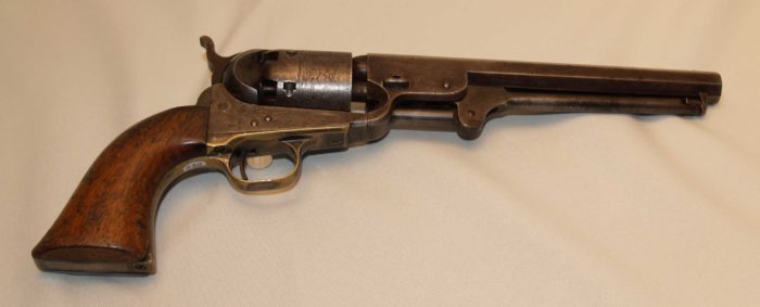 A metal pistol with wooden grips.
