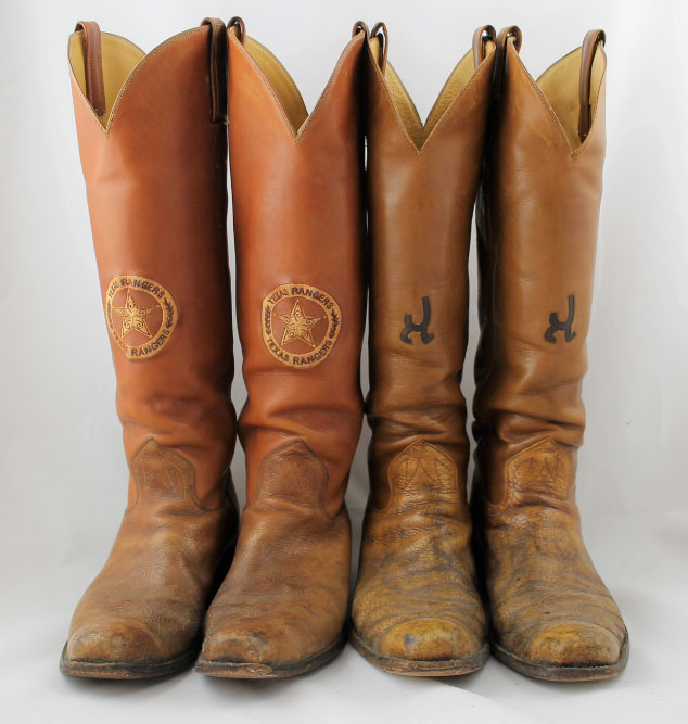 Two pair of worn brown leather cowboy boots. One pair has the circle star badge symbol and the other has a cattle brand on them.