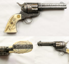 A heavily decorated Colt pistol with a silver metal body and bone grips. There is a carved leave motif on the body of the gun, an eagle carved on to on side of the grip and a longhorn on the other. On the butt of the gun it says "Company B State Ranger Force".