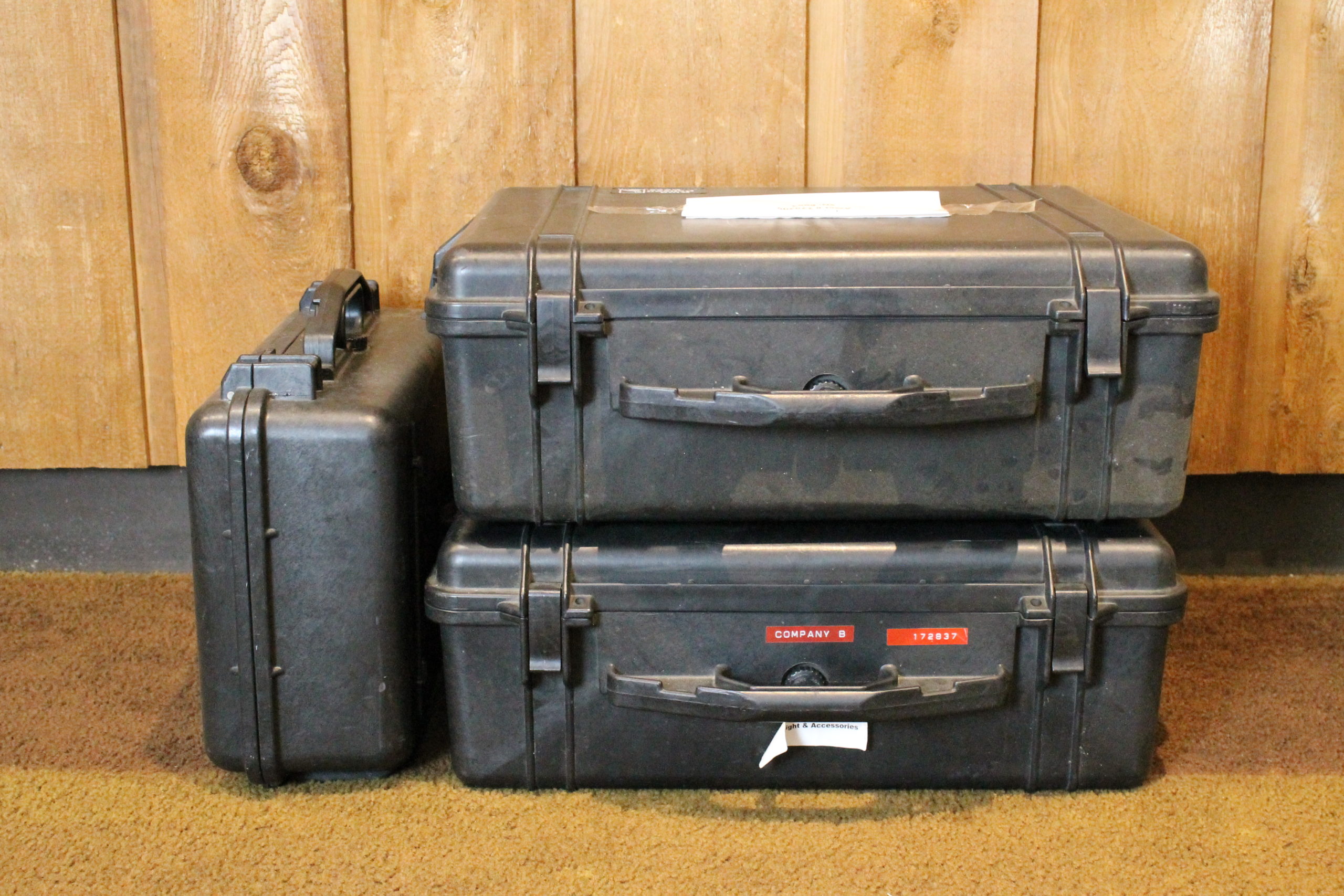 Three large black box shaped containers with handle with the words "Company B" on it.