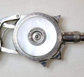 The back of a uniquely shaped pistol with a mother of pearl round center that reads "The Protector PAT. MCH. 6 83. Aug. 29.93.