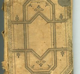 The back of an old tan tattered book with a dark blue/black geometric design on it.