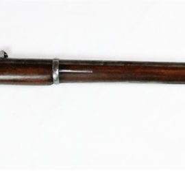 long rifle made of dark wood and silver metal