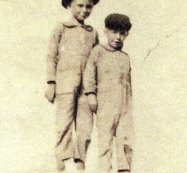 two young boys in gray with black hats