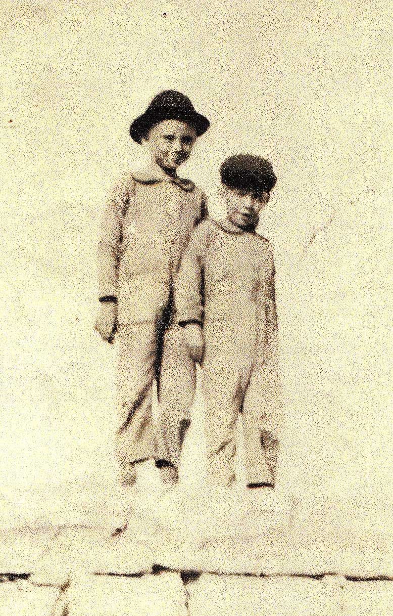 two young boys in gray with black hats