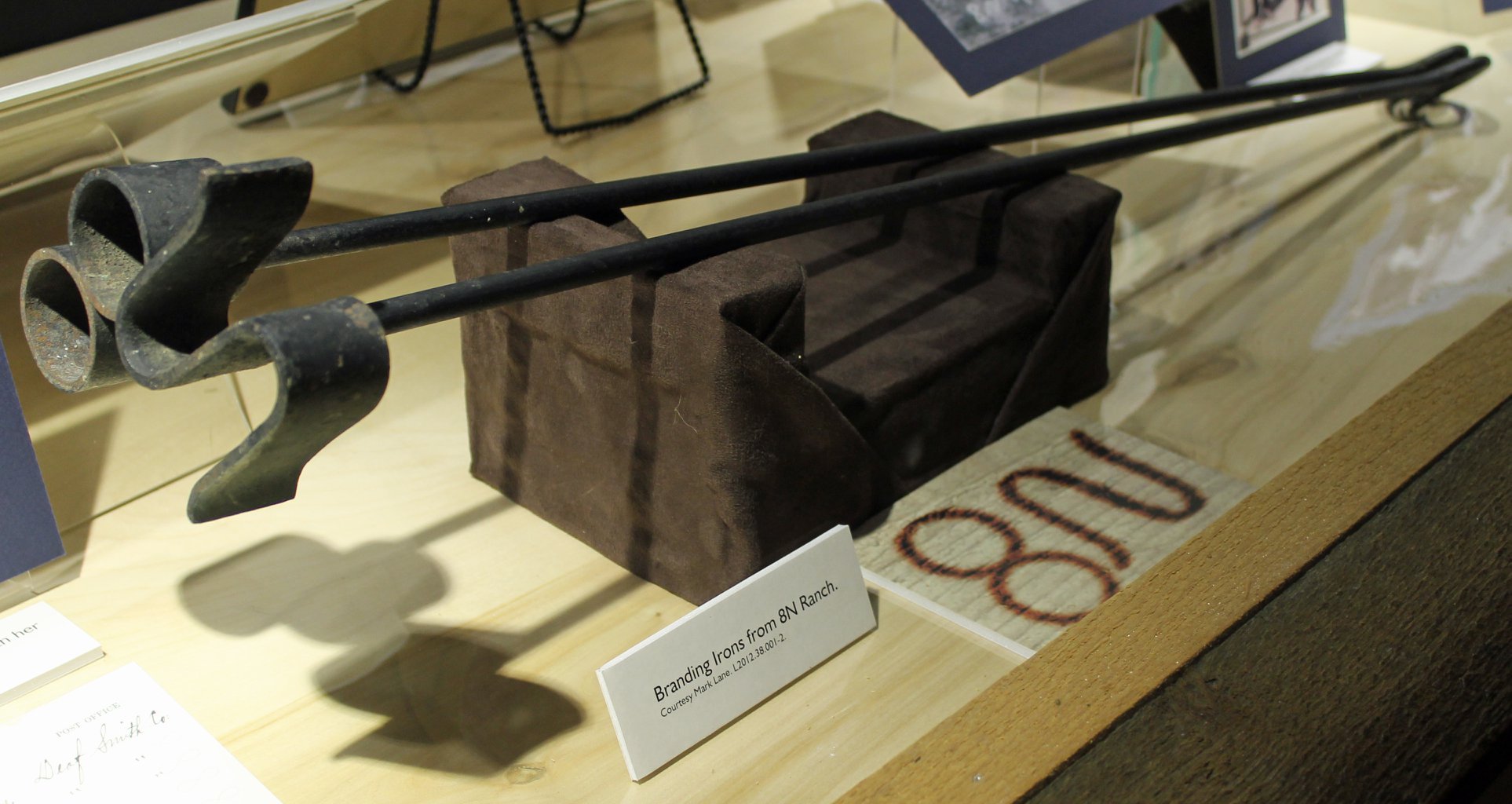 two branding irons in exhibit case
