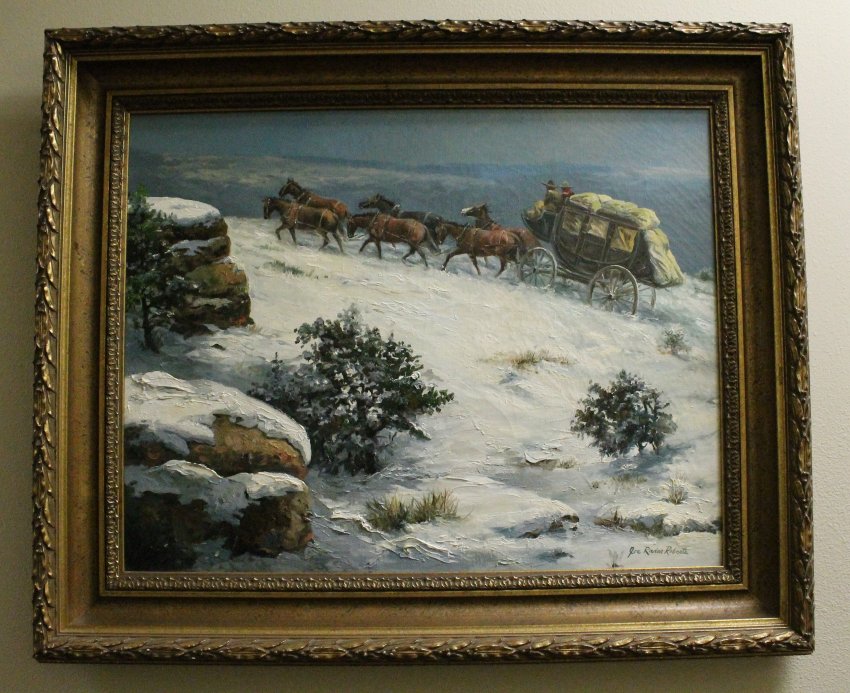 Stagecoach and horses climb snowy hilltop