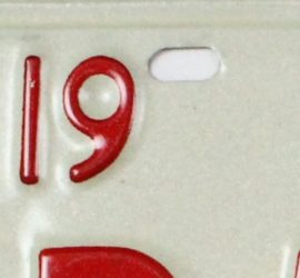 red number 19 and hole on white metal plate