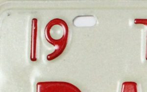 red number 19 and hole on white metal plate