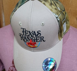 logo embroidered on pale brown hat with camo backing