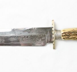 silver knife with horn handle topped with silver sculpted horse head
