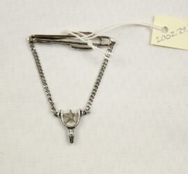 silver star in horseshoe connected to chains and locking mechanism