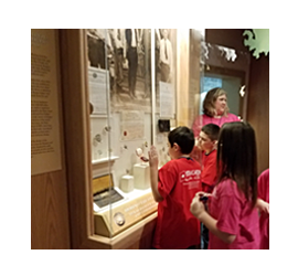 children looking at badge exhibit